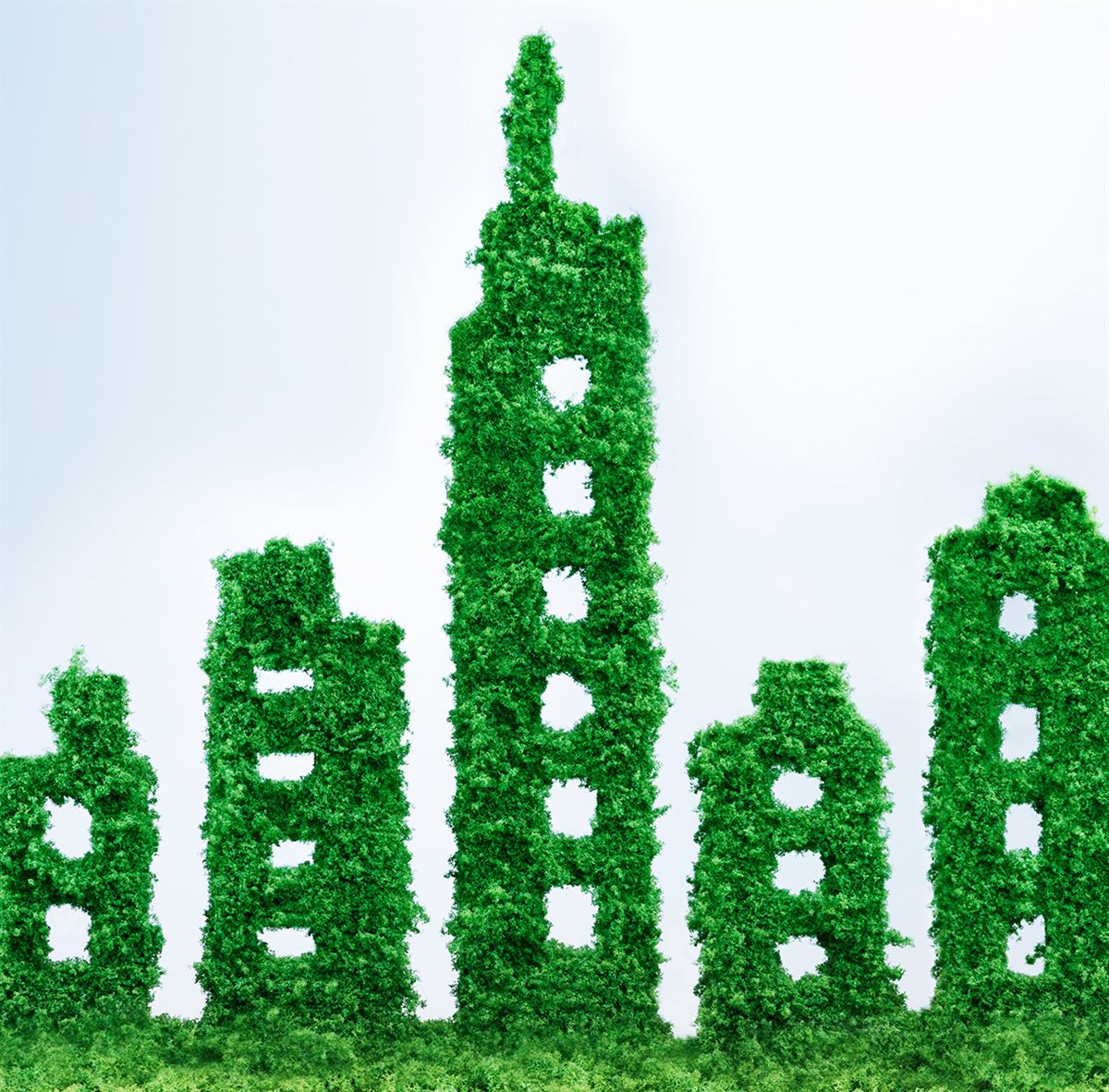 Kantoorgebouwen uitgebeeld met groene blaadjes